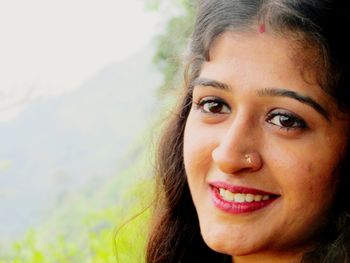 Close-up portrait of a smiling young woman