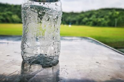 Close-up of water drop on plastic bottle on table