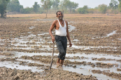 Full length portrait of man standing on land