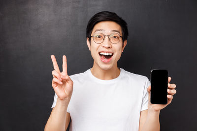 Man with smart phone against black background