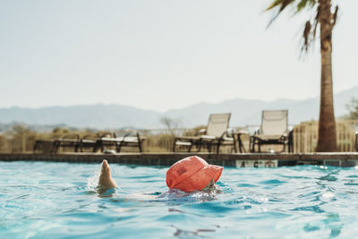 Close-up of person swimming in pool