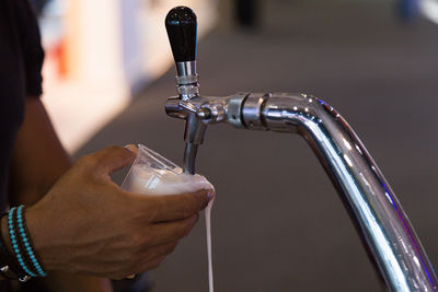 Close-up of hand holding glass of water