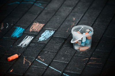 Close-up of chalk in container on floor