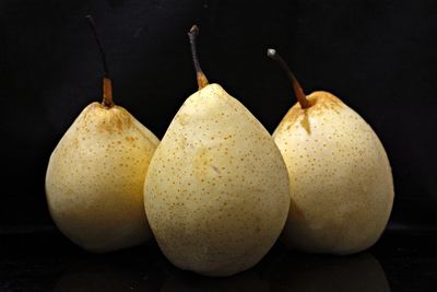 Close-up of pear over black background
