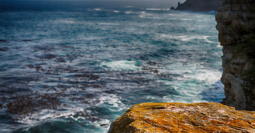 Rock formation on beach against sky