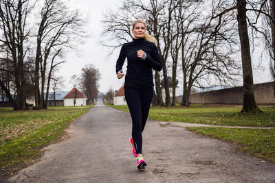 Portrait of young woman running