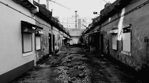 Street amidst buildings in city against clear sky