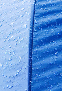 Full frame shot of wet blue umbrella during rainy season