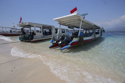 Boats in sea against sky