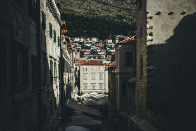 View looking down the center of busy old town dubrovnik buildings