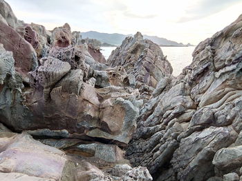 Rocks in sea against sky