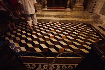 Low section of people walking in temple