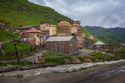 Buildings against sky with mountain in background