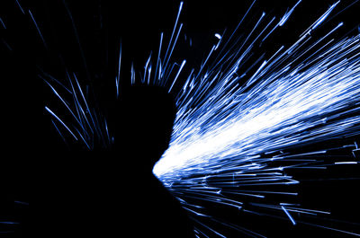 Low angle view of firework display against black background