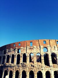 Low angle view of historical building against blue sky