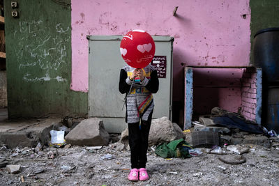 Full length of a woman standing against building