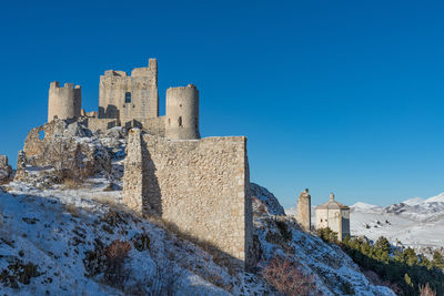 Low angle view of historic building against blue sky