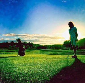 Scenic view of grassy field against cloudy sky