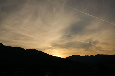 Silhouette mountains against sky at sunset