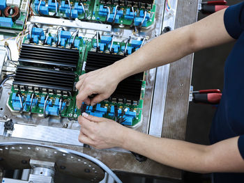 Technician connecting wires on circuit board