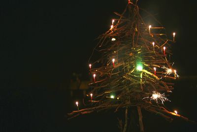 Low angle view of illuminated christmas tree at night