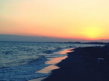 Scenic view of sea against orange sky