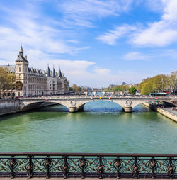 Bridge over river with city in background