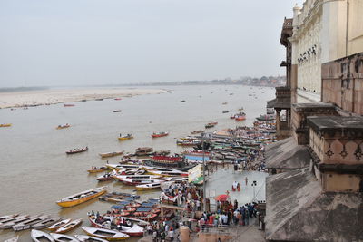 High angle view of people by sea against clear sky