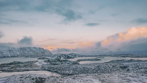 Scenic view of snowcapped mountains against sky during sunset