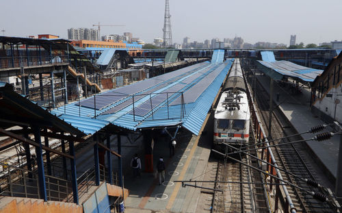 High angle view of railroad tracks amidst buildings in city