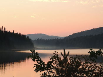 Scenic view of lake against sky during sunset