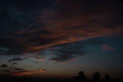 Low angle view of silhouette trees against sky at sunset