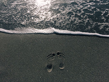 High angle view of footprints on beach