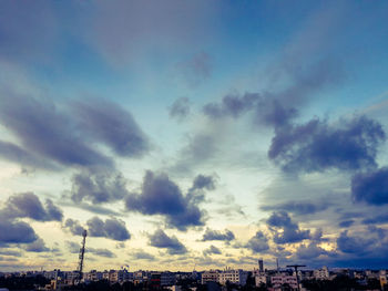 Low angle view of buildings against sky at sunset