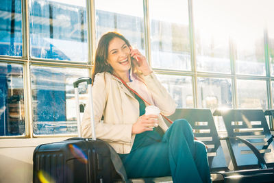 Portrait of young woman sitting in train