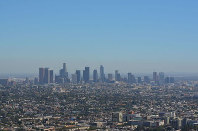 Aerial view of modern buildings in city against clear sky