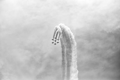 Low angle view of airplane flying against sky