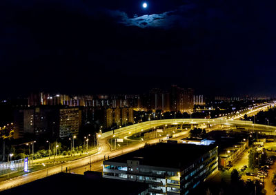 Illuminated cityscape against sky at night