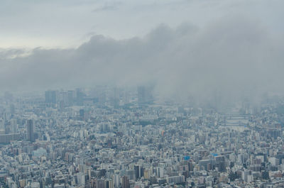 High angle view of buildings in city against sky