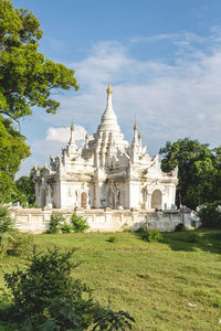 Close-up of pagoda against blue sky and trees