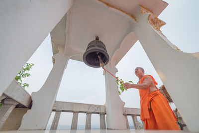 Low angle view of man standing by building