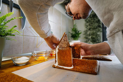 Midsection of man preparing food on table