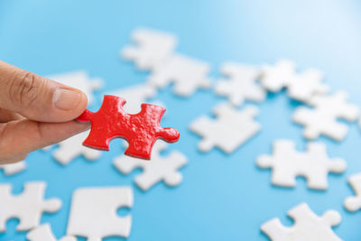 Cropped hand holding jigsaw piece