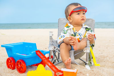 Boy sitting on beach