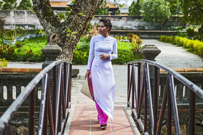 Woman standing by railing