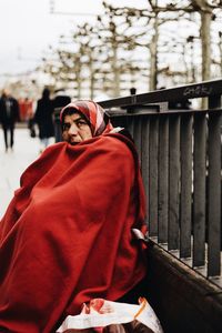 Portrait of man standing by railing