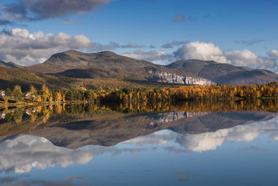 Beautiful mountainous landscape reflected on the water with clouds in the sky in norway