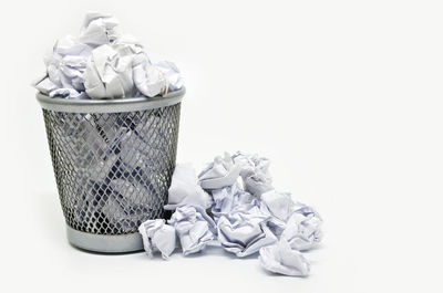 Garbage bin against white background