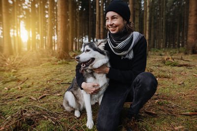 Young woman with dog in the forest