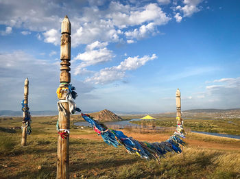 Panoramic view of cross on field against sky